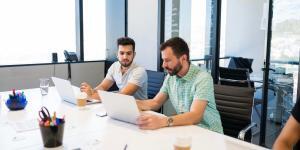 Men talking on laptop