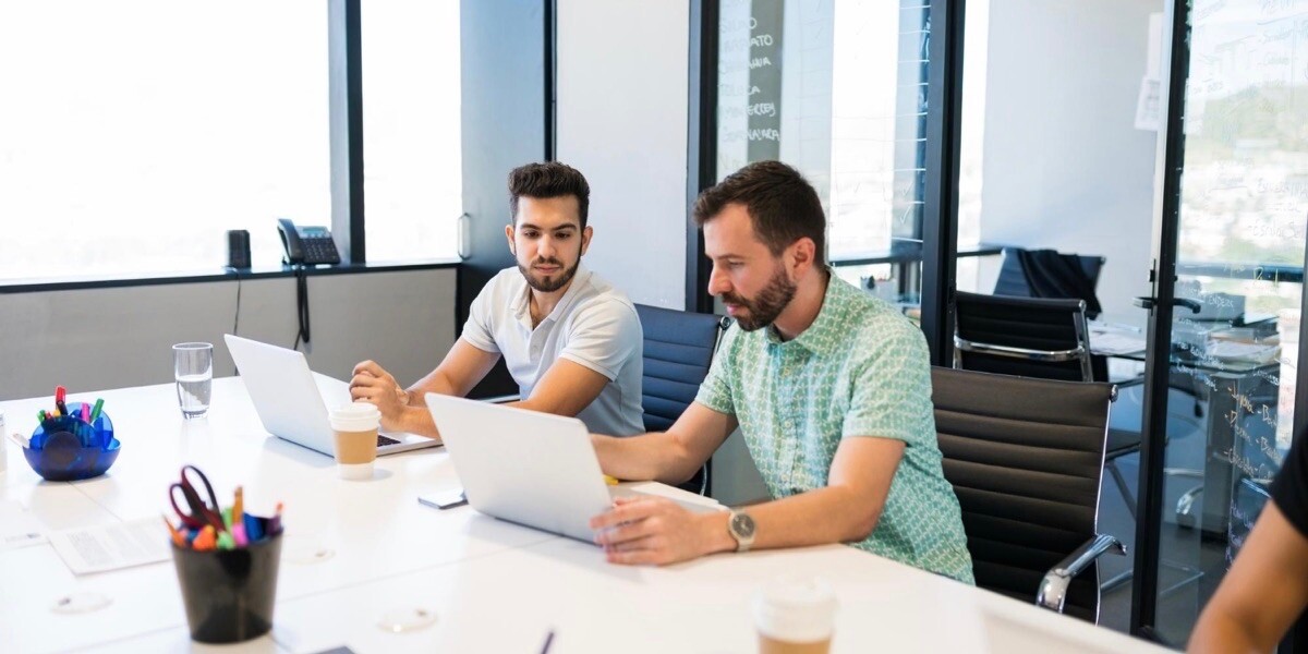 Men talking on laptop